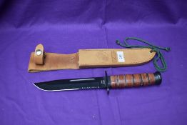 A USMC MFH Fighting Knife with leather scabbard, overall length 31cm