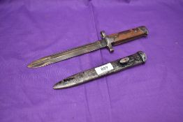 An Italian Model 1938 Modified Bayonet with metal scabbard, marked on grip H25961 overall length
