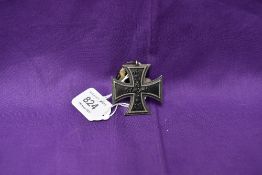 A German 1813-1914 Iron Cross with ribbon