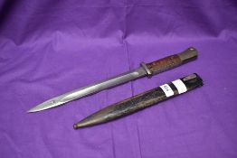 A German WW1 1884/98 Bayonet, wood and metal grip, makers marks Crown with ER Furt, blade edge
