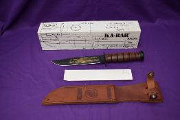 A Ka-Bar Knife, Pearl Harbour 60th Anniversary, with leather scabbard, overall length 31cm, in