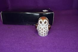 A Royal Crown Derby Owlet paper weight having gold stopper,with box.