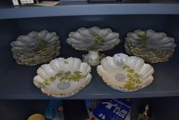 A collection of French ceramics having scalloped edges,gilt accents and Hydrangea design to cream