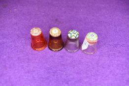 A selection of four fine and detailed miniature glass makers thimbles having various designs