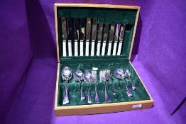 A wooden canteen of stainless steel cutlery