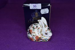 A Royal Crown Derby meadow rabbit paper weight having gold stopper,with box.
