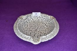 A crackle glazed German pottery ashtray.