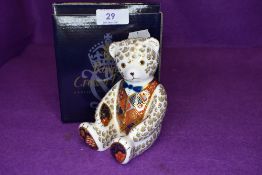 A Royal Crown Derby teddy bear paper weight having silver stopper,with box.