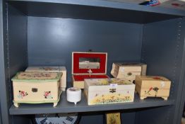 A collection of vintage musical jewellery boxes, some with floral painting and another in the form