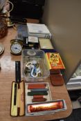 A mixture of items including vintage travel clock, picture frames and writing accessories.