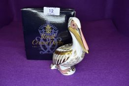 A Royal Crown Derby pelican having gold stopper,with box.