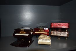 A selection of musical piano shaped boxes.