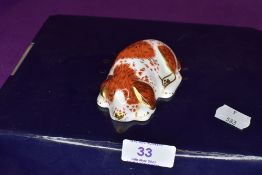 A Royal Crown Derby puppy paper weight having gold stopper,with box.