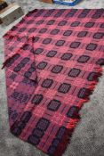 A large Welsh pure new wool blanket in vibrant purple, black and cerise.