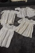 Four items of early 20th century baby clothing,including fine muslin jacket with fine embroidery.