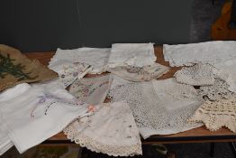 A collection of modern damask table cloths and vintage and antique examples having deep crotchet