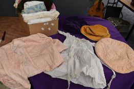 A mixed collection of vintage and antique items including childrens gowns,bed jackets, hats and