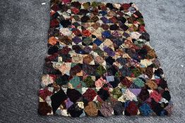 An unusual throw/quilt having a variety of raised sections of fabric, around mid to late 19th