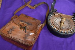 Two vintage leather bags having stitched and embossed details.