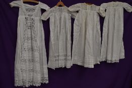 Four late 19th and early 20th century baby gowns and dresses, some incredible techniques an