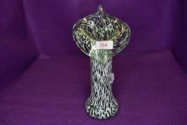 A vintage green and white art glass vase.