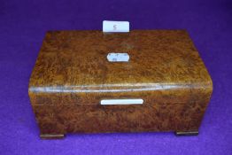 A vintage maple veneered box having two internal compartments.