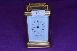 A Thwaites and reed carriage clock having bevelled glass gallery and to sides.