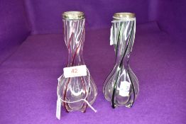 Two vintage vases having having colourful twists throughout and silver bands to necks.