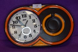 A German 1970s Schatz Elexacta ceramic wall clock,having brown and orange ground.