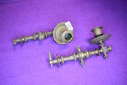 A pair of ornately decorated antique detachable piano or carriage candle sticks