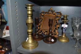 Four vintage candle sticks including one having blue and white detail to stem and an antique cast