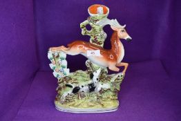 A Staffordshire flat back spill vase depicting leaping dog and deer.