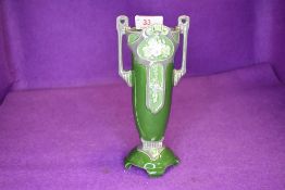 An Eichwald twin handled vase having strong art nouveau styling with green ground and grey accents