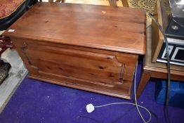 A modern pine bedding box on casters