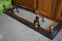 A late 19th or early 20th Century copper and cast fire fender having ball and claw finials and a