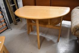 A modern Ercol light ash gateleg table, 1156
