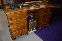 A modern pine dressing table, having four drawers to each side and ledge back, width approx. 125cm
