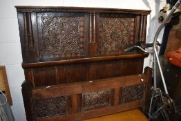 A Period oak carved panel bed head and foot