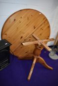 A modern pine circular extending dining table