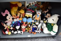 A shelf of Mickey Mouse, Winnie the Pooh, Snoopy and similar soft toys and collectables