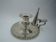 An Edwardian silver chamber stick and snuffer having gadrooned decoration to base rim, sconce and