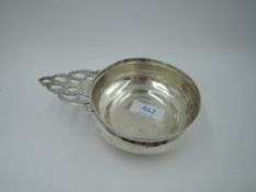 A late Victorian silver porringer having pierced cast handle, London 1900, makers mark worn,