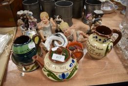 A mixed lot of ceramics including piano babies,Staffordshire spill vases, moto ware and more.