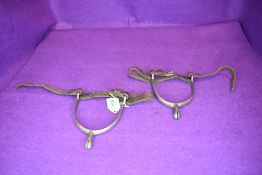 A pair of vintage leather and metal spurs.