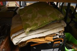 A selection of soft furnishings including ochre velvet curtains and throws.