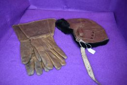 A pair of mid century leather flying gloves and similar flying cap or hat