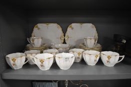 A collection of Shelley in the Diamonds pattern, having Queen Anne shaped cups with gold print,