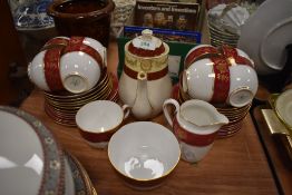 A part tea service by Tuscan China having gilt and burgundy design