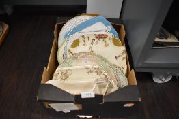 A box of vintage and antique plates, various styles and decorations including hand tinted examples