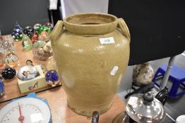 A large twin handled earthen ware jar.